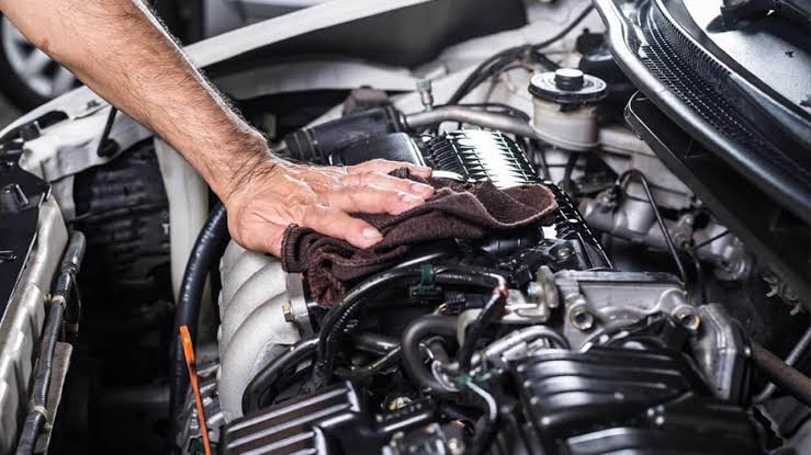 Technician performing engine maintenance